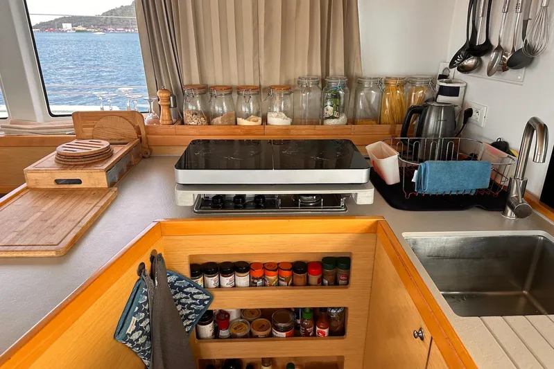  Yacht Photos Pics Modern kitchen in 2016 Lagoon 42 catamaran with stove, sink, and organized spices.