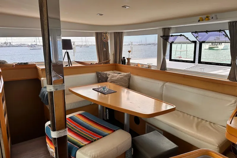  Yacht Photos Pics Interior of 2016 Lagoon 42 catamaran with cozy seating and ocean view.