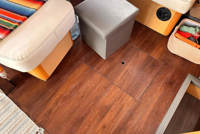  Yacht Photos Pics Interior of 2016 Lagoon 42 catamaran with wood flooring and cozy seating area.