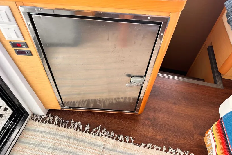  Yacht Photos Pics Stainless steel fridge on Lagoon 42 catamaran, 2016 model, with wooden flooring and rug.