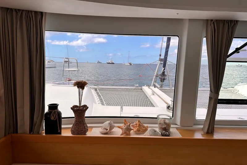  Yacht Photos Pics View from inside a 2016 Lagoon 42 catamaran, showcasing ocean and decorative items.
