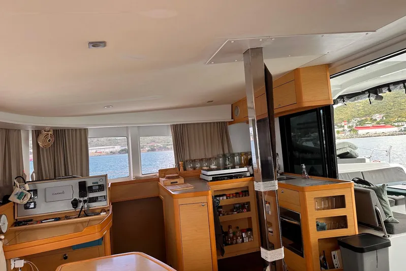  Yacht Photos Pics Interior of 2016 Lagoon 42 catamaran with navigation equipment and kitchen area.