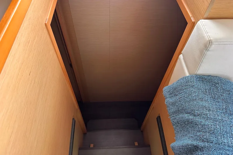  Yacht Photos Pics Interior view of 2016 Lagoon 42 yacht, featuring wooden stairs and seating area.