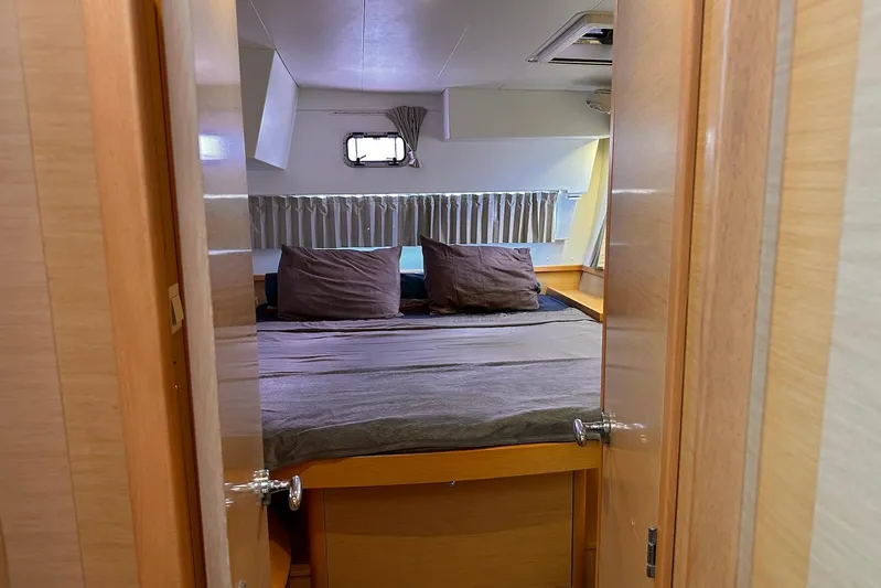  Yacht Photos Pics Cozy cabin interior of 2016 Lagoon 42 catamaran with double bed and window.