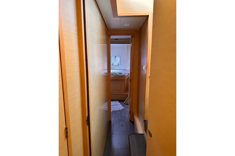  Yacht Photos Pics Interior hallway of 2016 Lagoon 42 catamaran, leading to a cozy cabin.