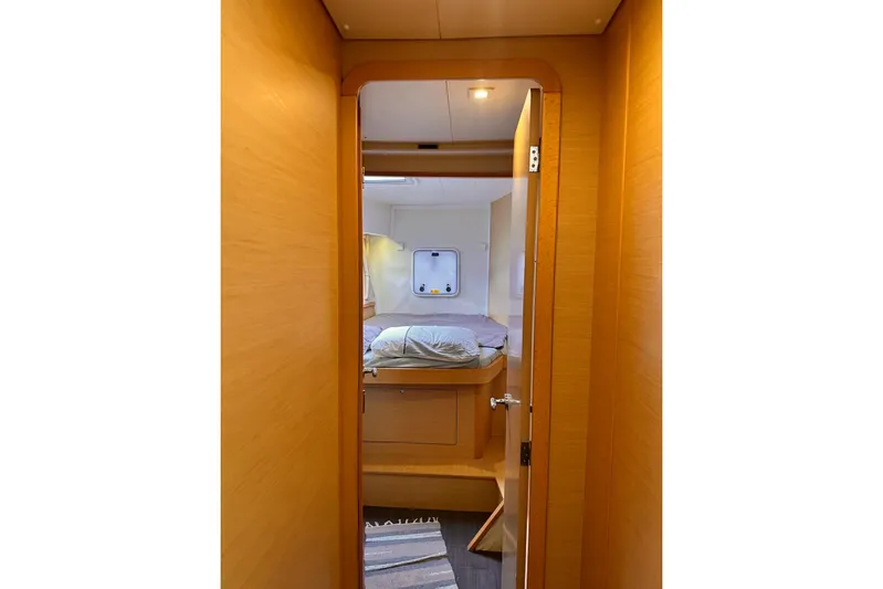  Yacht Photos Pics Interior view of 2016 Lagoon 42 yacht cabin with bed and window.