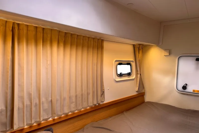  Yacht Photos Pics Interior cabin of 2016 Lagoon 42 catamaran with curtains and window.