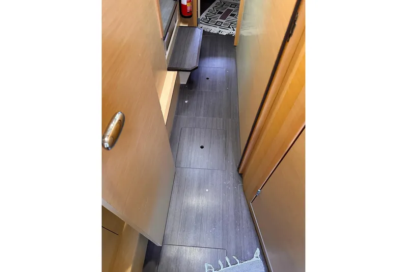  Yacht Photos Pics Narrow hallway inside 2016 Lagoon 42 catamaran with wooden flooring and steps.
