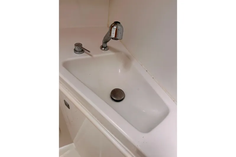 Yacht Photos Pics Compact white sink with chrome faucet in 2016 Lagoon 42 yacht bathroom.