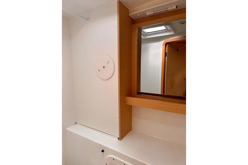  Yacht Photos Pics Bathroom interior of 2016 Lagoon 42 yacht with mirror and wooden accents.