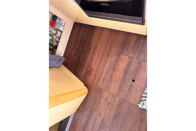  Yacht Photos Pics Interior of 2016 Lagoon 42 yacht with wooden flooring and storage area.