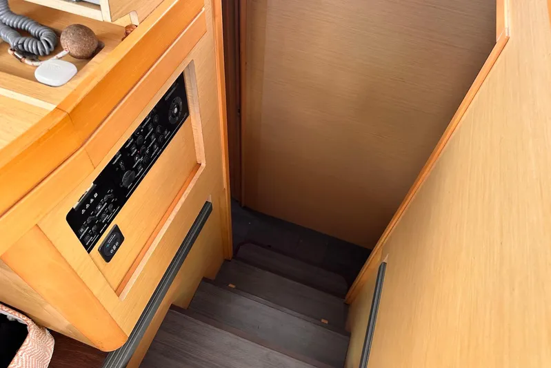  Yacht Photos Pics Interior stairs of a 2016 Lagoon 42 catamaran with control panel.