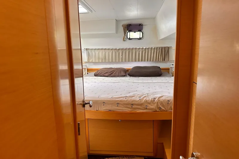  Yacht Photos Pics Cozy bedroom interior of 2016 Lagoon 42 catamaran with double bed and window.