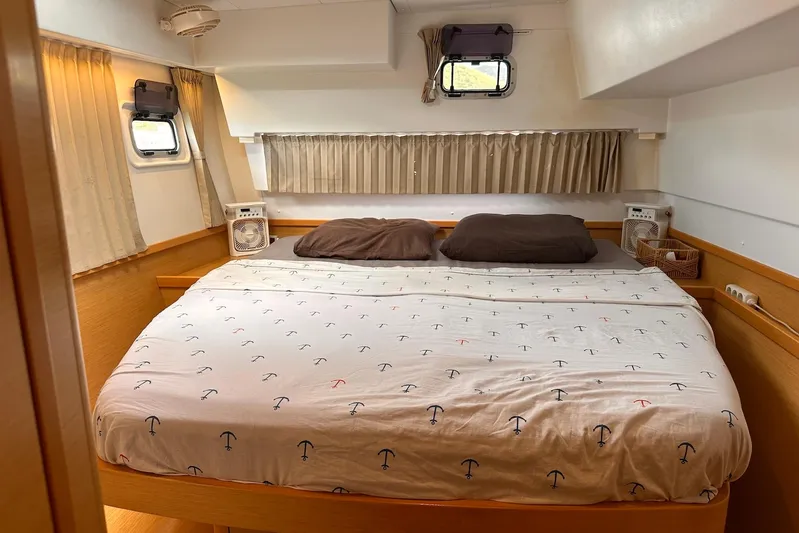  Yacht Photos Pics Cozy bedroom in 2016 Lagoon 42 catamaran with nautical-themed bedding and natural light.