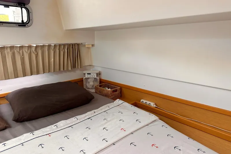  Yacht Photos Pics Cozy cabin interior of 2016 Lagoon 42 catamaran with nautical-themed bedding.