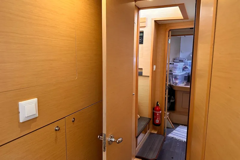  Yacht Photos Pics Interior of 2016 Lagoon 42 yacht, featuring wooden paneling and a fire extinguisher.
