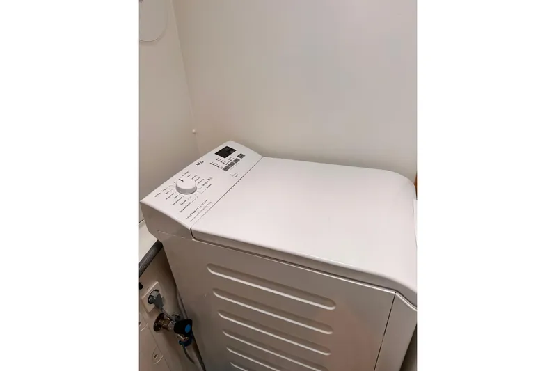  Yacht Photos Pics White top-loading washing machine in a compact laundry space.