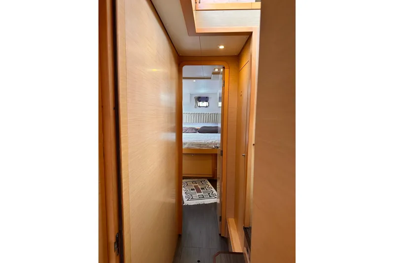  Yacht Photos Pics Interior hallway of 2016 Lagoon 42 yacht, leading to a cozy bedroom.