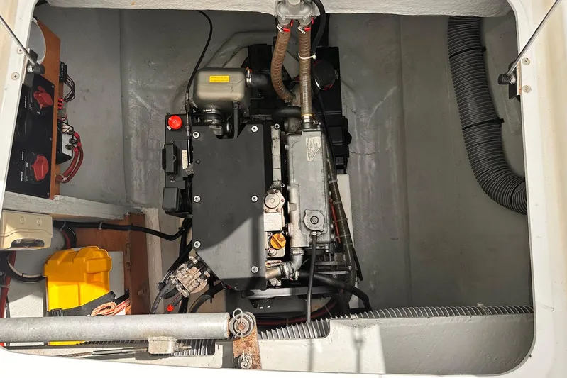  Yacht Photos Pics Engine compartment of a 2016 Lagoon 42 catamaran, showcasing mechanical components and wiring.