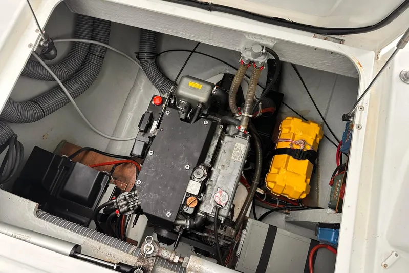  Yacht Photos Pics Engine compartment of a 2016 Lagoon 42 catamaran, showcasing mechanical components and wiring.