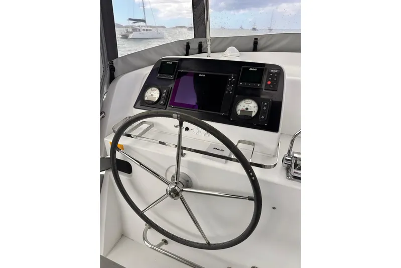  Yacht Photos Pics Helm of 2016 Lagoon 42 catamaran with navigation instruments and steering wheel.