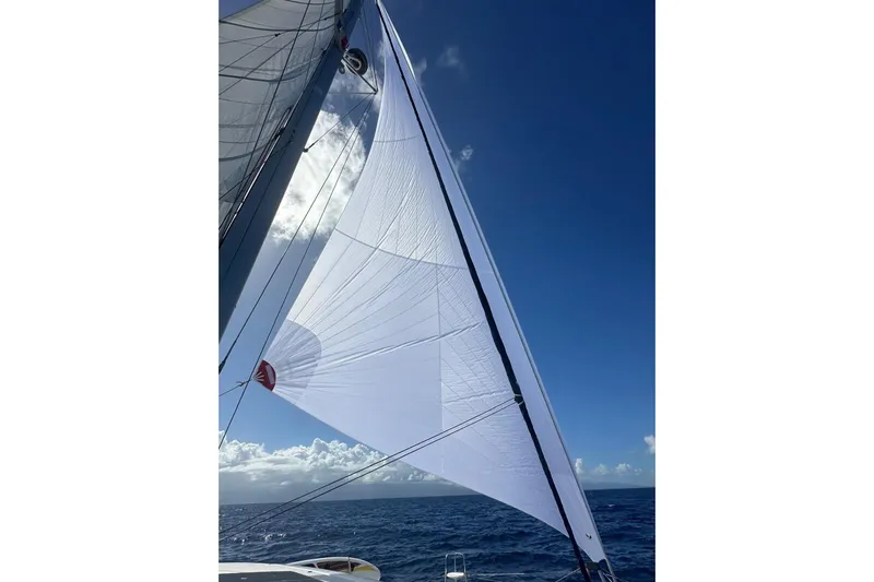  Yacht Photos Pics Sailing on a 2016 Lagoon 42 catamaran with white sails against a clear blue sky.