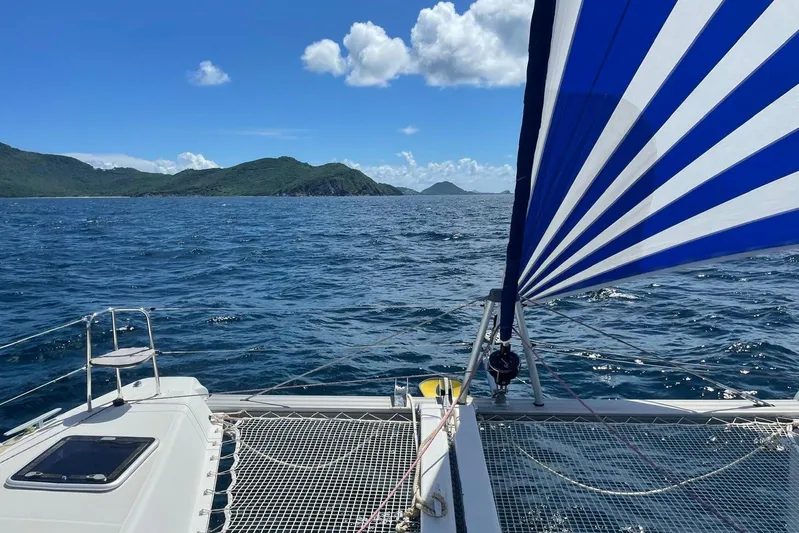  Yacht Photos Pics Lagoon 42 catamaran sailing with blue and white sail, scenic ocean view, 2016 model.