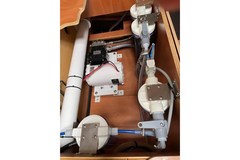  Yacht Photos Pics Engine compartment of a 2016 Lagoon 42 catamaran, showcasing mechanical components and wiring.