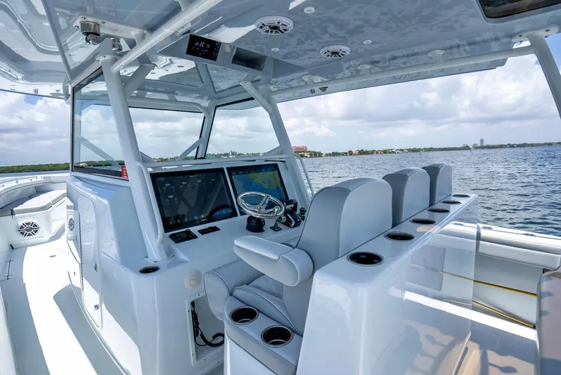  Yacht Photos Pics 2023 Yellowfin 42 Offshore boat interior with advanced navigation system and seating on open water.