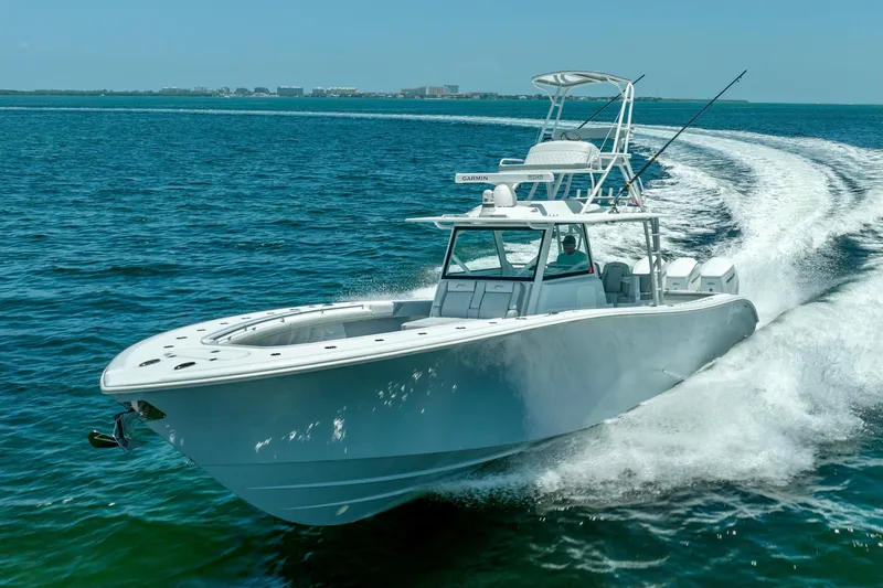  Yacht Photos Pics 2023 Yellowfin 42 Offshore boat cruising on open water, showcasing sleek design and performance.