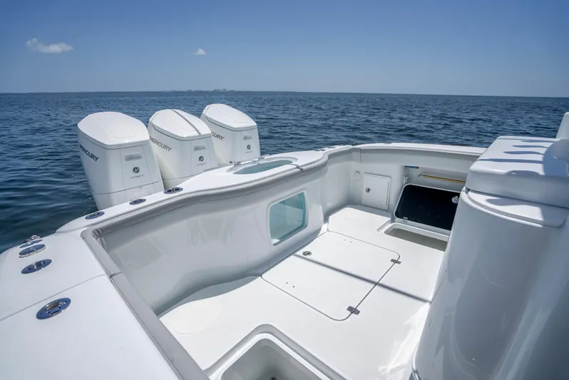  Yacht Photos Pics 2023 Yellowfin 42 Offshore boat with triple outboard engines on open sea.