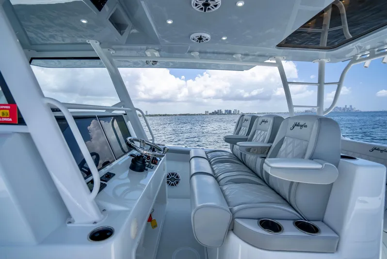  Yacht Photos Pics 2023 Yellowfin 42 Offshore boat interior with luxurious seating and ocean view.