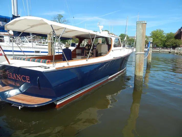  Yacht Photos Pics 2001 Hinckley Classic 36 Picnic Boat docked in a marina, featuring elegant design and canopy.