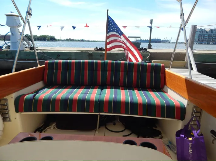  Yacht Photos Pics 2001 Hinckley Classic 36 Picnic Boat with striped seating and American flag at dock.