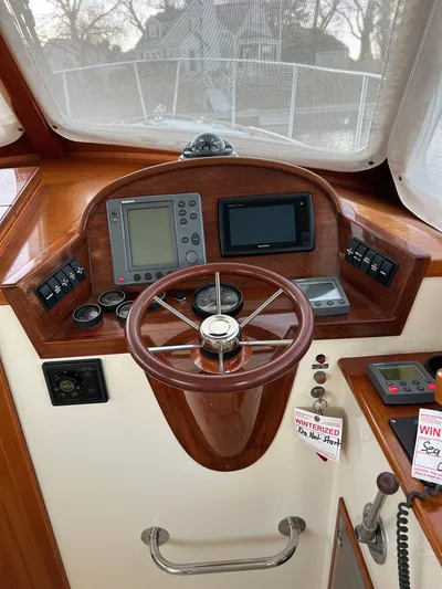  Yacht Photos Pics Helm of 2001 Hinckley Classic 36 Picnic Boat with navigation instruments and wooden steering wheel.