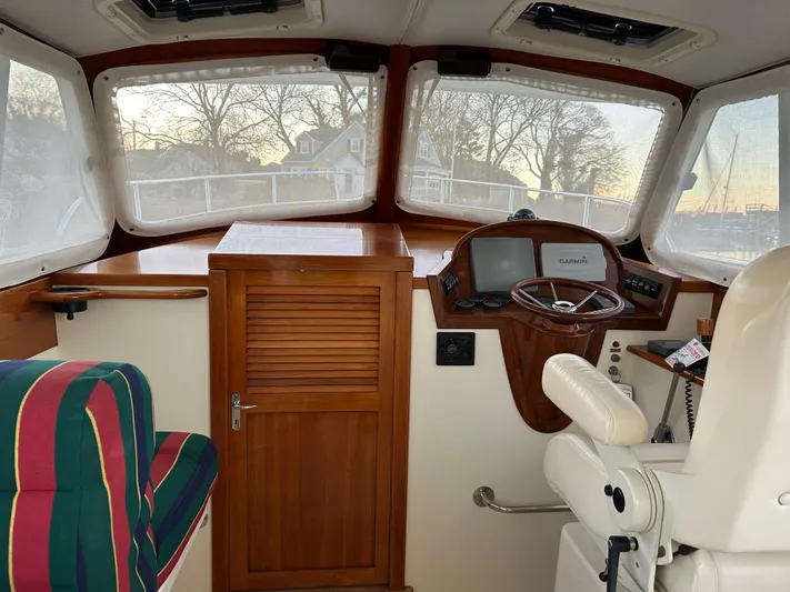  Yacht Photos Pics Interior of a 2001 Hinckley Classic 36 Picnic Boat with helm and seating.