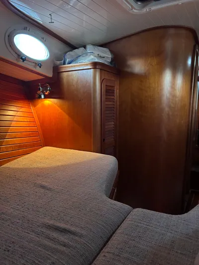  Yacht Photos Pics Cozy cabin interior of 2001 Hinckley Classic 36 Picnic Boat with wooden finish.