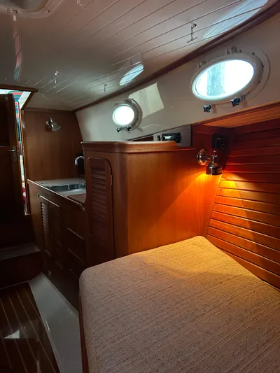  Yacht Photos Pics Interior of 2001 Hinckley Classic 36 Picnic Boat with wood paneling and cozy lighting.