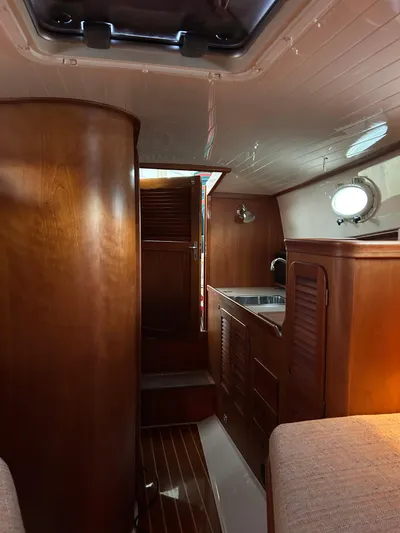 Yacht Photos Pics Interior of 2001 Hinckley Classic 36 Picnic Boat with wooden cabinetry and cozy seating.