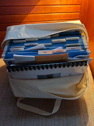  Yacht Photos Pics Organized documents in a beige bag on a Hinckley Classic 36 Picnic Boat, 2001 model.