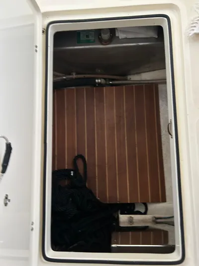  Yacht Photos Pics Storage compartment on a 2001 Hinckley Classic 36 Picnic Boat with wooden flooring.