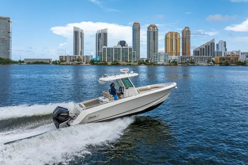 My Sherry III Yacht Photos Pics 2018 Boston Whaler 280 Outrage cruising on water with city skyline backdrop.
