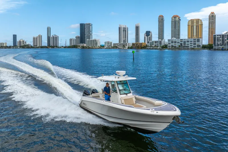 My Sherry III Yacht Photos Pics 2018 Boston Whaler 280 Outrage cruising near city skyline on a sunny day.