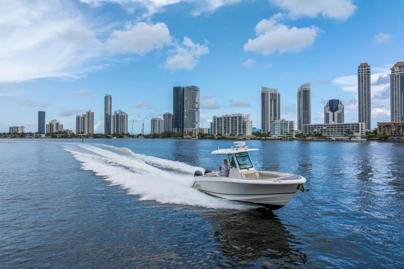 My Sherry III Yacht Photos Pics 2018 Boston Whaler 280 Outrage cruising near city skyline on a sunny day.