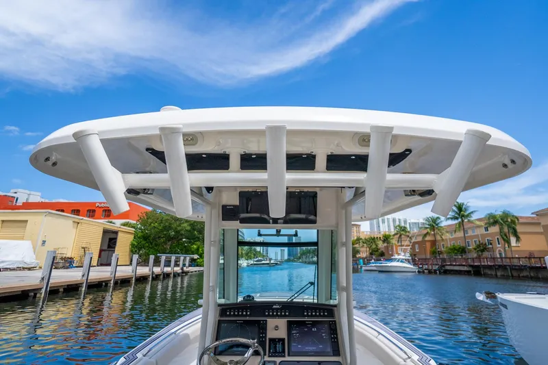 My Sherry III Yacht Photos Pics 2018 Boston Whaler 280 Outrage boat console with rod holders, docked in a scenic marina.