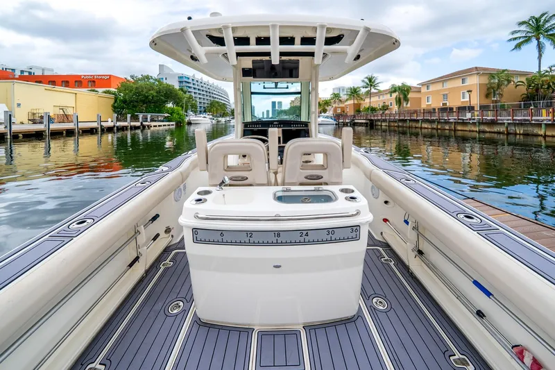 My Sherry III Yacht Photos Pics 2018 Boston Whaler 280 Outrage boat interior, docked in a scenic canal setting.