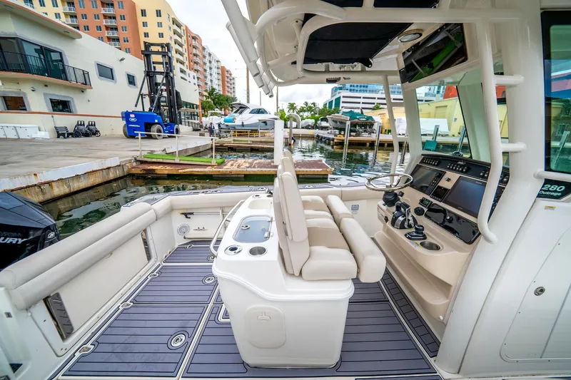 My Sherry III Yacht Photos Pics 2018 Boston Whaler 280 Outrage boat interior at marina, featuring helm and seating area.