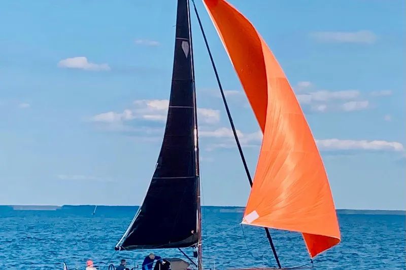 Saffire Yacht Photos Pics Saffier 33 Life sailboat with orange sail on open water, 2022 model.
