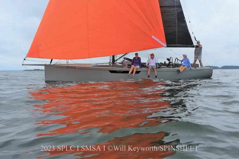 Saffire Yacht Photos Pics Saffier 33 Life 2022 sailboat with vibrant orange sail on calm waters.