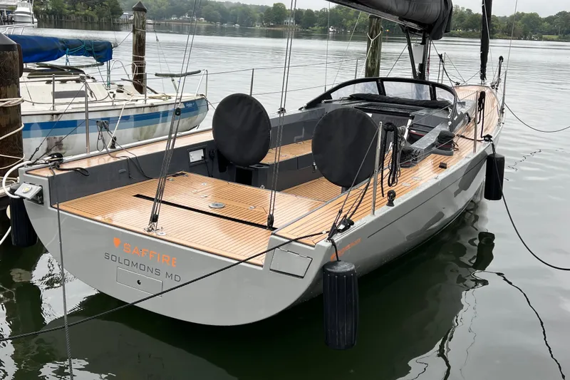 Saffire Yacht Photos Pics 2022 Saffier 33 Life sailboat docked, featuring sleek design and wooden deck.